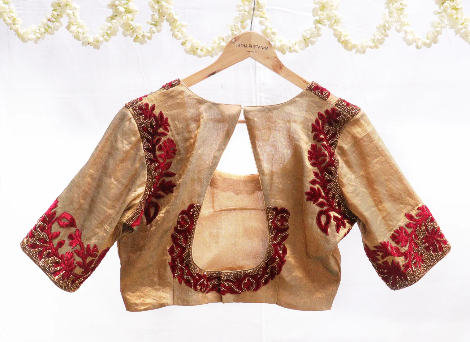 Saucy gold,Kanjeevaram tissue, with red velvet applique potli bag.